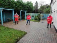 The Team show off their hard work, the tiled area has been scrubbed and power-washed